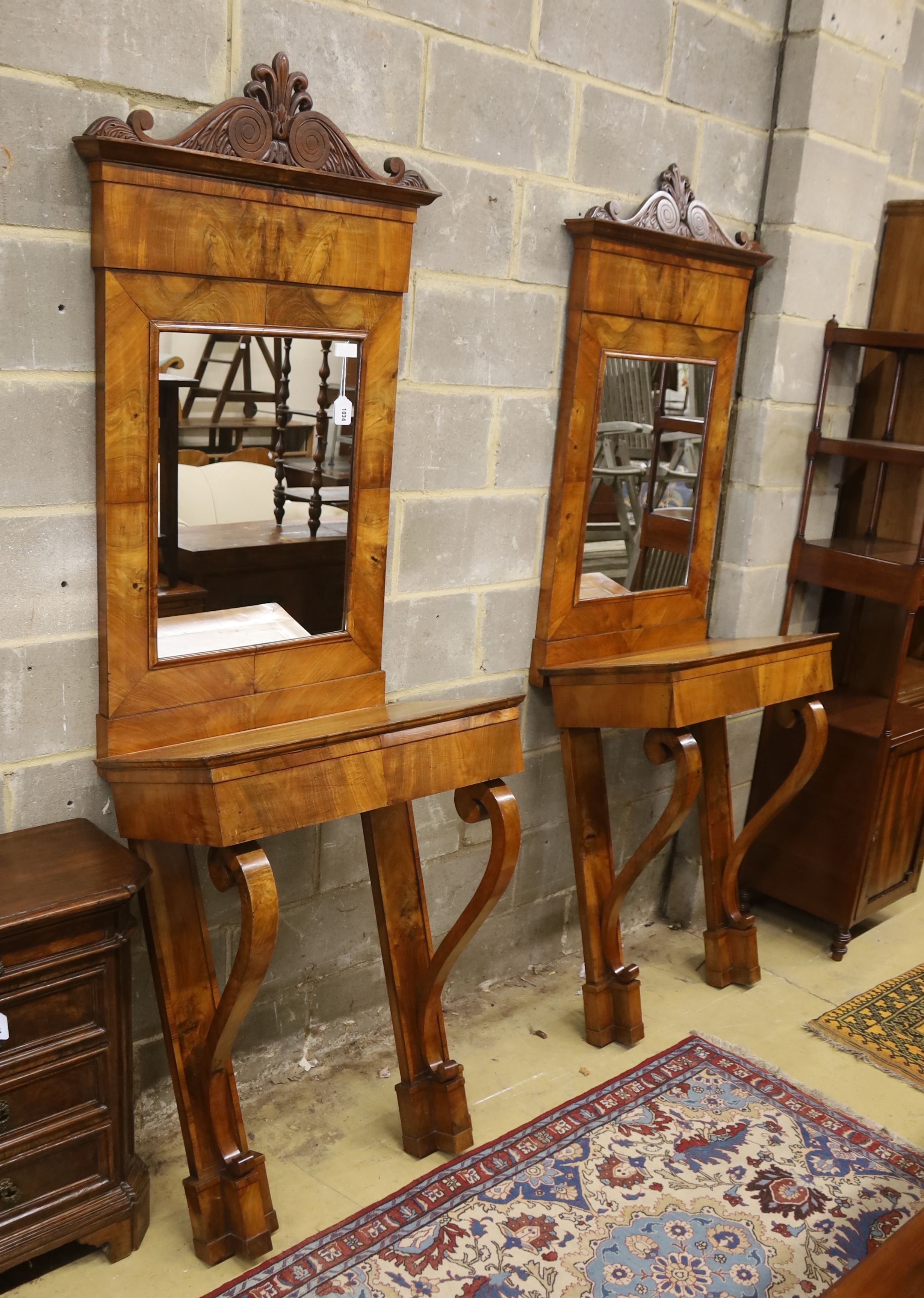 A pair of 19th century Italian mahogany pier tables with mirrors, width 72cm, depth 42cm, height 218cm